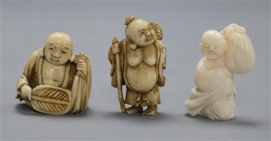 Three early 20th century Japanese netsuke of Hotei, two in ivory, one coral (562, 563, 571)